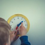 Boy with play clock for adjust